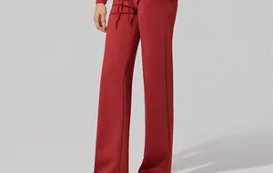 Detail shot of red air layer high-waisted wide-leg sports pants with drawstring waist.