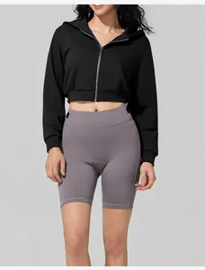 Detailed view of a women's black cropped zip-up hoodie for sports and fitness.