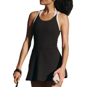 Black U-back tennis dress with white contrast straps and quick-dry fabric on model
