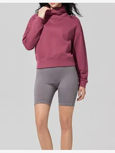 Female model wearing a maroon stand-up collar sweatshirt and grey sports biker shorts