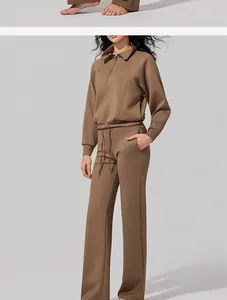 Detail view of a women's brown half-zip lounge sweatshirt and wide-leg yoga pants set