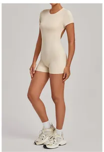 Detailed side view of a beige backless one-piece yoga bodysuit showing athletic fit