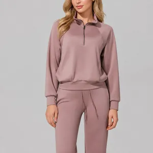 Women's mauve activewear set with half-zip sweatshirt and high-waist drawstring pants.