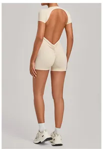 Rear view of a backless beige bodysuit showing ruched detailing and sculpting fit.