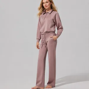 Mauve two-piece lounge set with half-zip sweatshirt and wide-leg yoga pants.