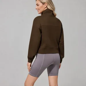Women's brown loose fit funnel neck sweatshirt with grey athletic shorts for outdoor sports