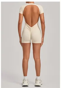 Detail view showing the backless design of a beige athletic yoga bodysuit with scrunch butt