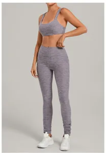 Detailed view of purple heathered brushed fabric sports bra and high-waisted leggings.
