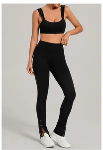 Detail of black brushed yoga set featuring split hem leggings with metal snap buttons