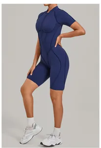 Detailed side view of navy blue half-zip yoga jumpsuit with contoured seams on model