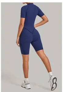 Rear view of a navy blue athletic yoga romper featuring a high neck and short sleeves.