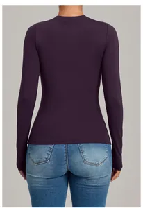Detailed back view of a tight purple long-sleeve yoga top for high-intensity fitness training