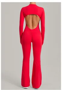 Back view of a red long sleeve backless yoga jumpsuit featuring flared leg design