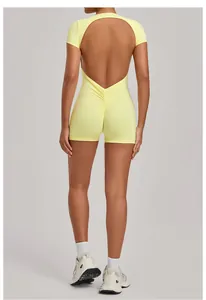 Close-up back view of yellow backless yoga bodysuit featuring ruched detail and open back