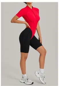 Side detail of a backless fitness bodysuit featuring red zipper top and black shorts