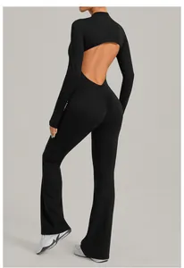 Back view of a black backless long-sleeved flared yoga jumpsuit showing the open back detail