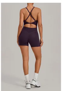 Back view of dark purple yoga bodysuit with criss-cross straps and open back cutout