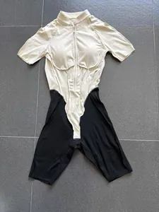 Detailed front view of a color-block fitness bodysuit with stand collar and zipper design