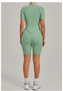 Back view detail of a sage green stand collar yoga romper with high-stretch athletic fabric
