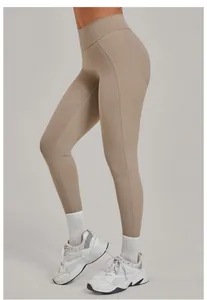 Dettaglio laterale di leggings da yoga beige a vita alta con cucitura push-up