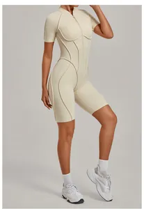Athletic beige one-piece yoga bodysuit featuring a half-zip mock neck and short sleeves