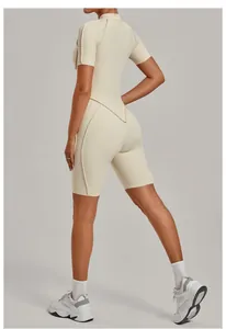Detailed back view of a beige stand-up collar half-zip yoga jumpsuit with biker shorts
