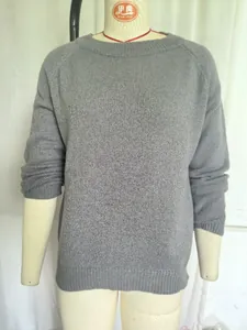 Detailed texture of a grey crewneck knitted sweater, soft and basic pullover for women.