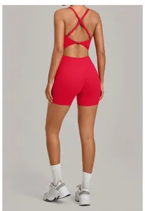 Detailed back view of red cross-back one-piece yoga bodysuit featuring high-waisted shorts