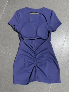 Detailed back view of a purple backless yoga bodysuit featuring ruched fabric design