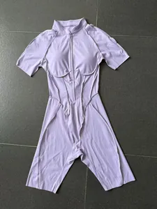 Lavender one-piece yoga jumpsuit with half-zip stand collar and sleek front seam details