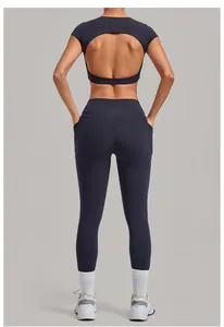 Back view of navy blue two-piece yoga set with open back top and leggings with pockets