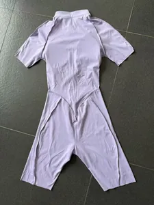 Back view detail of a lavender high-neck short-sleeve yoga bodysuit workout jumpsuit