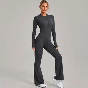 Sleek grey long-sleeved one-piece yoga jumpsuit with flared legs and front zipper detail