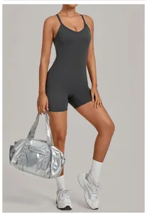 Detail shot of a charcoal grey V-neck one-piece yoga bodysuit styled with a silver gym bag