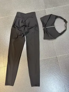 Two-piece black yoga set featuring scrunch butt leggings and a back zipper sports bra detail.