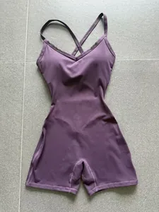 Close-up of purple sweetheart neck one-piece yoga bodysuit with cross-back straps