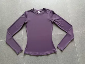 Slim fit dark purple long sleeve athletic yoga top with high stretch breathable fabric