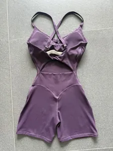 Back view of purple cross-back yoga romper with cutout detail and heart-shaped stitching