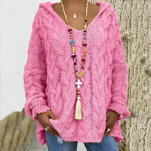 Gros plan détaillé de la texture épaisse en tricot torsadé rose et du motif de ce pull à capuche