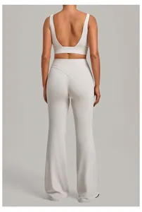 Back view of a light grey yoga set featuring a sports bra and high-waisted flare pants.