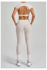 Back view of a beige 2-piece yoga set with an open back top and matching leggings