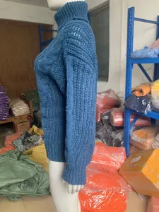 Profile view of women's blue knitted turtleneck sweater displayed on a white mannequin