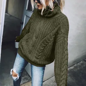 Detailed view of women's dark olive green chunky cable knit turtleneck sweater.