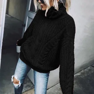 Close-up detail of black oversized cable knit turtleneck sweater with warm ribbed cuffs