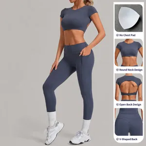 Two-piece slate blue yoga set featuring a short sleeve crop top and high-waisted pocket leggings.