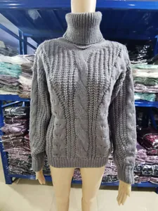 Detail view of a women's gray turtleneck cable knit sweater displayed on a mannequin.