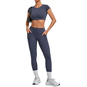 Women's two-piece yoga set with cropped short sleeve top and leggings with side pockets