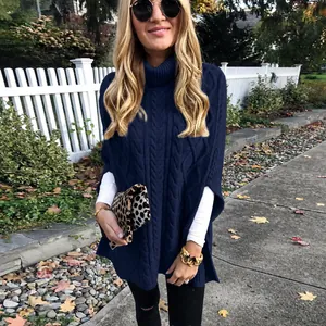 Detail van marineblauwe kabelgebreide poncho met hoge kraag voor dames in herfststijl