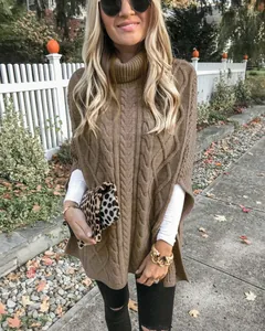 Detail van een bruine coltrui-poncho met kabelpatroon voor een trendy herfstachtige outfit
