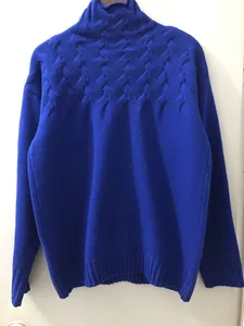Cozy cobalt blue women's turtleneck sweater featuring intricate cable knit shoulder details